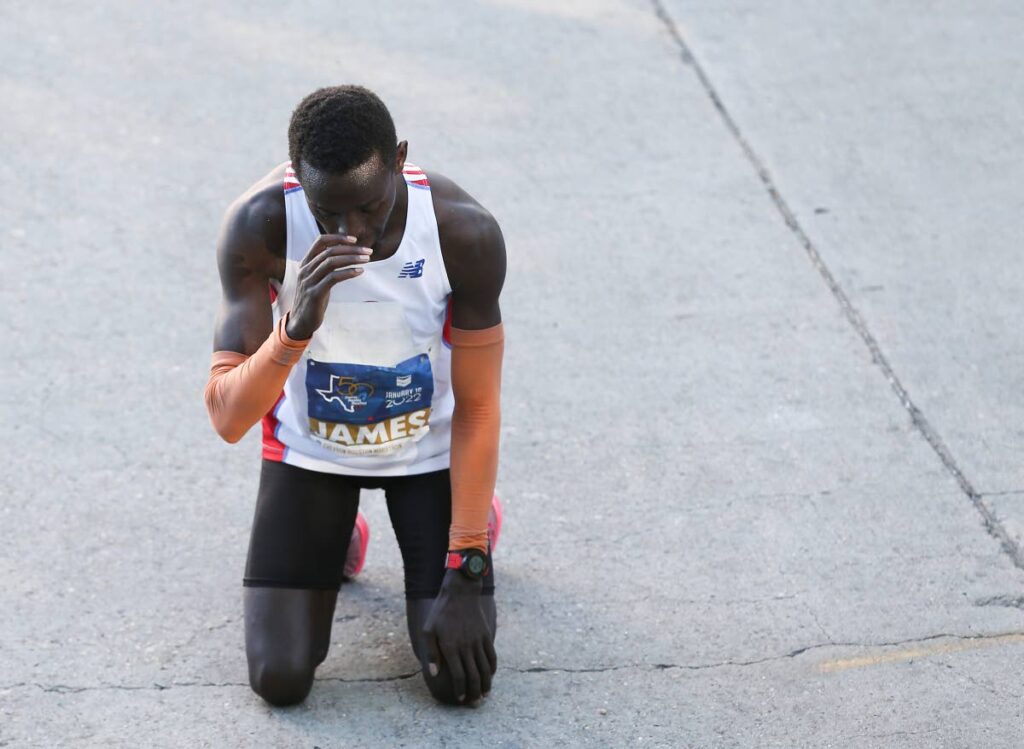 In this photo taken on Sunday, Kenya’s James Ngandu pauses after winning the 50th Chevron Houston Marathon. Ngandu finished the race at 2:11:03. (via AP) -