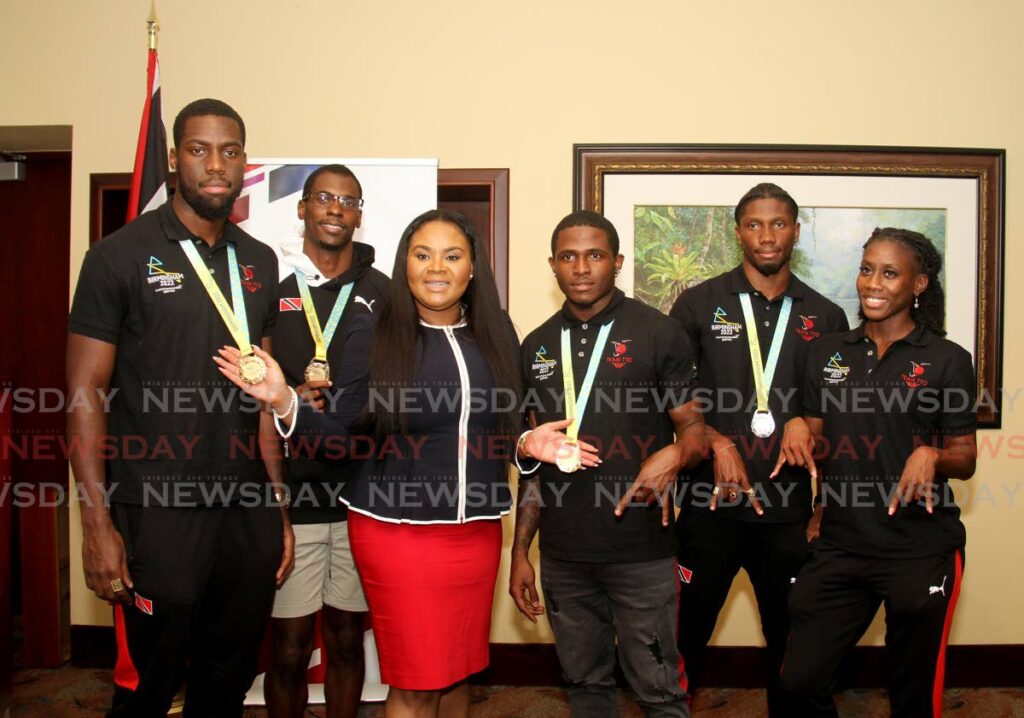 TT athletes Kashief King (left), Dwight St Hillaire (second from left), Che Lara (third from right), Jerod Elcock (second from right) and Mauricia Prieto (right), are joined in photo by Sports Minister Shamfa Cudjoe at the VIP Lounge, Piarco International Airport on Thursday, upon their return from the Commonwealth Games in Birmingham, England. - AYANNA KINSALE (via: newsday.co.tt)