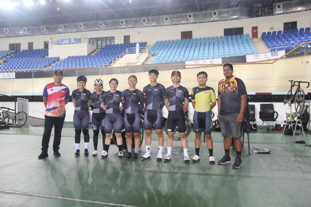 HAPPY VISITORS: Members of the Malaysian junior cycling team,  including coach Muhammad Zamani bin Mustarudin, right, at the National Cycling Velodrome, Couva, on Thursday. (Image obtained at trinidadexpress.com)