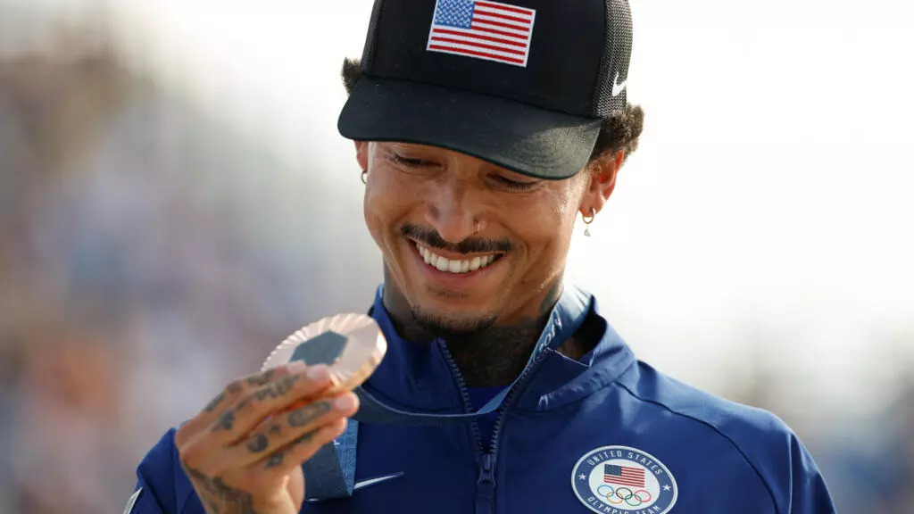 Nyjah Huston holds his bronze medal after the victory ceremony for the men's street skateboarding event on July 29, 2024. © Odd Anderson, AFP (Image obtained at france24.com)