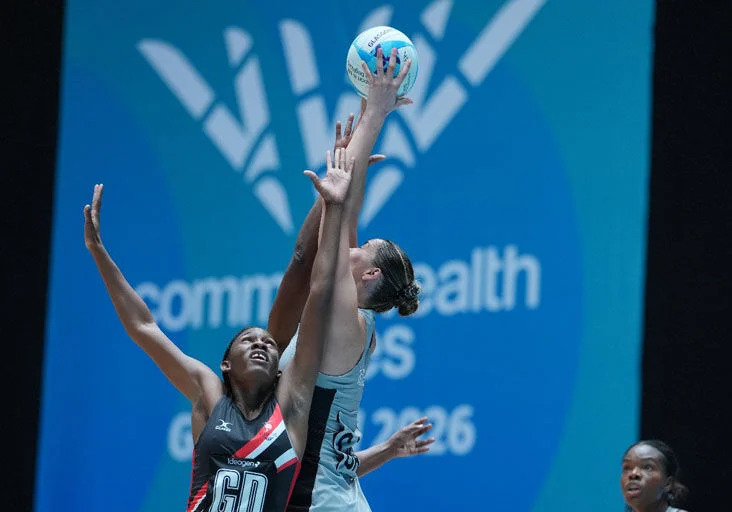 REACHING UP: New Zealand’s Amelia Walmsey, right, reaches for the ball during the preliminary round pool B netball match against Trinidad and Tobago at the Commonwealth Games in Glasgow, Scotland, yesterday. New Zealand won 83.23. (Image obtained at trinidadexpress.com)